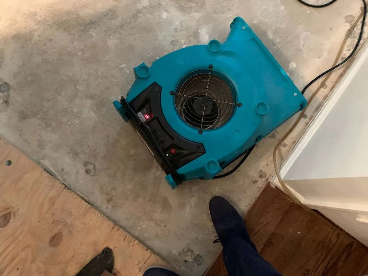 Air mover drying subfloor during Leak Detection & Repair in Broadalbin